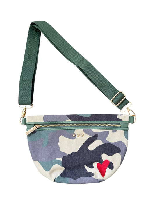 A small crossbody fanny pack with a green adjustable strap and a green, blue, and beige camouflage pattern body. It features a red embroidered heart on the front and gold-tone hardware.