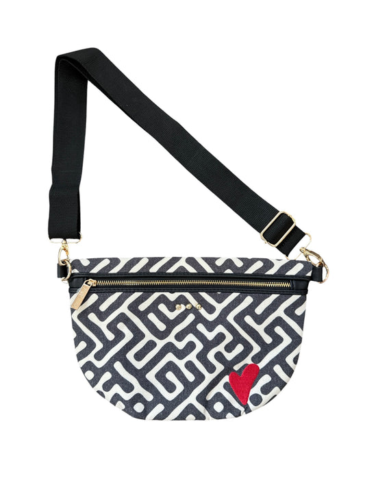 A black and white geometric patterned crossbody bag with a red heart on the front, a black adjustable strap, and gold-tone hardware, shown against a plain white background.