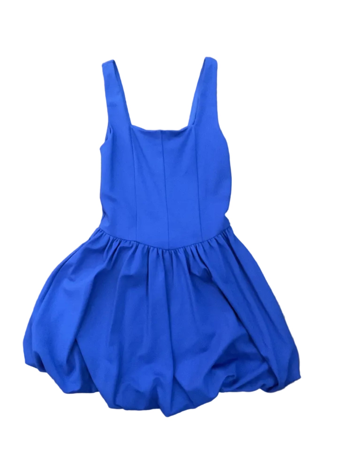 A bright royal blue sleeveless dress with a gathered empire waist and wide straps, bubble bottom, laid flat on a brown wood floor.